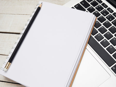 Workplace - laptop, notebook, pen, and pencil for remote work on a white wooden table. Freelance...