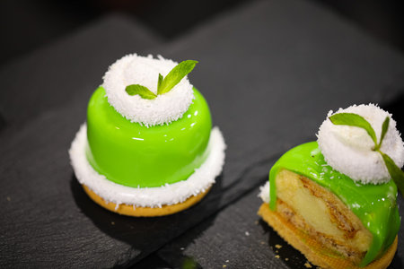 Indulge in Mini Desserts with Green Glaze, Coconut, and Mint for a delightful culinary experience