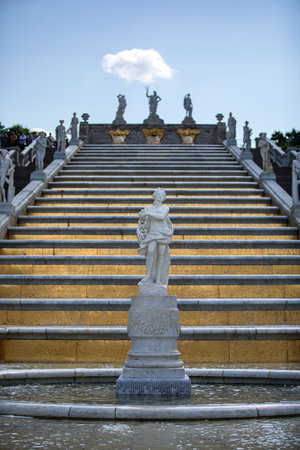 A prominent statue depicting a man standing atop a grand set of stairsの写真素材