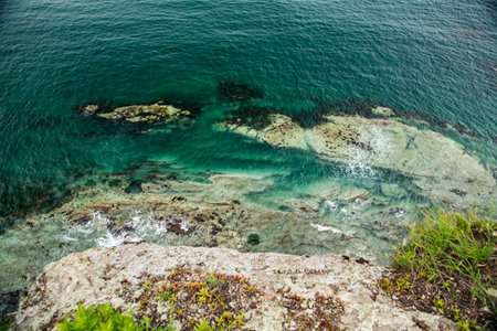 A breathtaking view of the vast ocean from the high top of a cliffの写真素材