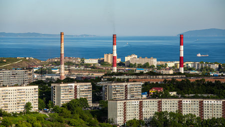 A vibrant cityscape featuring a vast body of water in the background