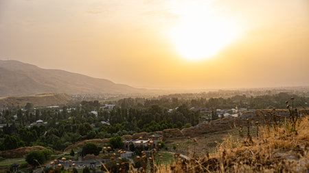 A stunning sunset casts vibrant colors over ancient architecture in a serene, beautiful landscapeの写真素材