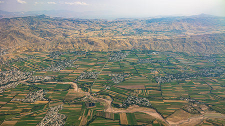 An Aerial View of Mountainous Terrain and Bustling Agricultural Fields in Vibrant Colors