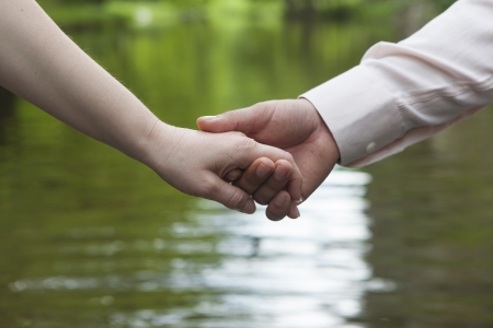 young couple doing handshake in the parkの写真素材