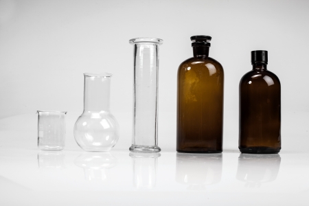 Pharmacy bottles and test-tubes on white background の写真素材