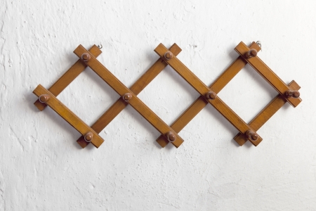 Clothes hangers on the wall under sunlightの写真素材