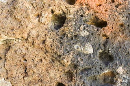 Old rock closeup under bright sunlight as a textureの写真素材