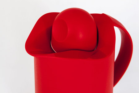 red plastic water jug with white backgroundの写真素材