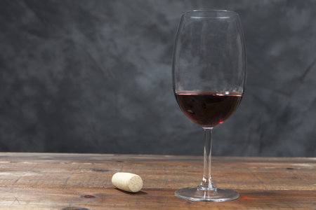 Glass of red wine on a wooden table