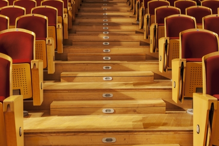  rows of red theater seats with wooden armのeditorial素材