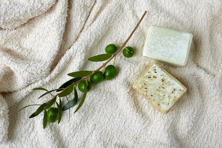 Handmade olive soap with olive branch and a towel.の写真素材