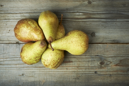 Yellow pears on a wooden tableの写真素材