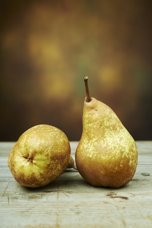 Yellow pears on a wooden tableの写真素材