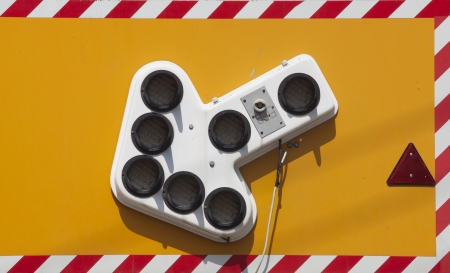 Go to the left, yellow sign with lighting arrowの写真素材