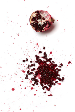 Red pomegranate fruit seeds on a tableの写真素材