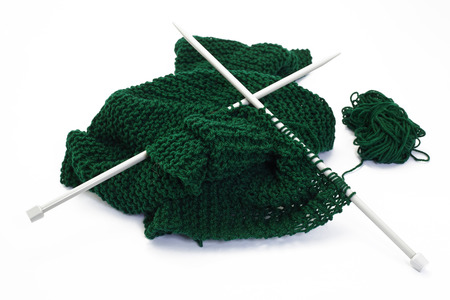 green wool cloth while knitting with needles の写真素材