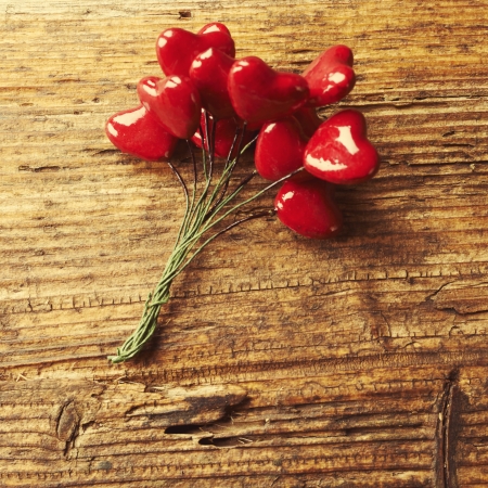 Vintage style photo. Valentines Day, red heart on wooden background.の写真素材