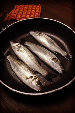 Vintage style photo, fresh fish, sea bass, ready for cookingの写真素材