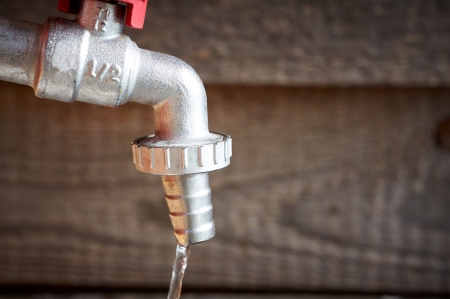 vintage water tap against on wooden の写真素材