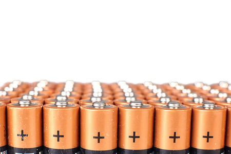 gold batteries in rows with silver tops close upの写真素材