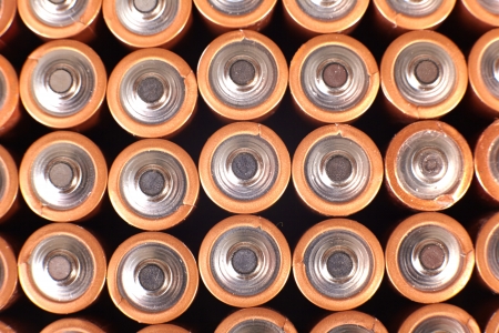 gold batteries in rows with silver tops close upの写真素材