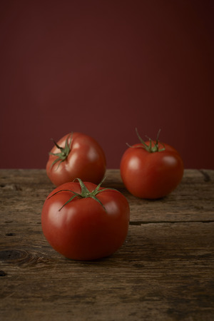 fresh red tomatoes on a wooden tableの写真素材