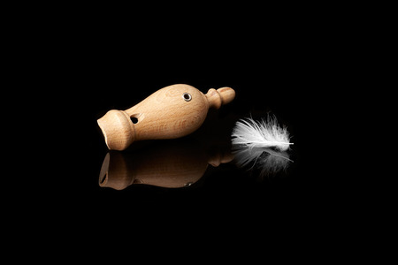 wooden whistles for calling ducks with a featherの写真素材