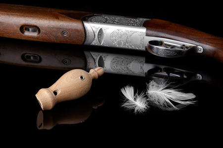 wooden whistles for calling ducks with a feather and a hunting gun.の写真素材