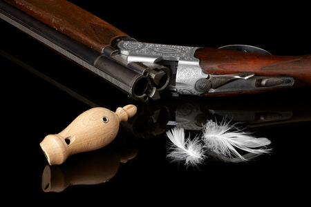 wooden whistles for calling ducks with a feather and a hunting gun.の写真素材