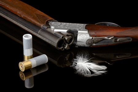 hunting gun with white feather and cartridge.の写真素材