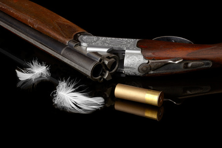hunting gun with white feather and cartridge.の写真素材