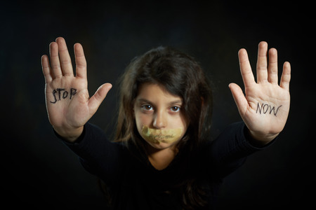 Children violence  Stop now are write on extended girlの写真素材