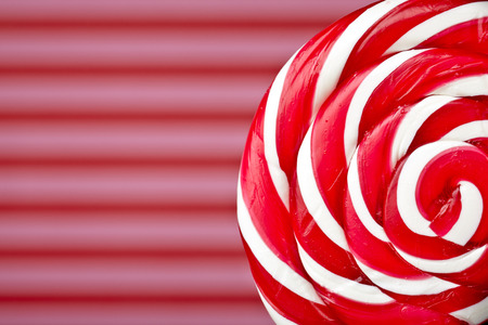 red and white large spiral lollipop on stickの写真素材