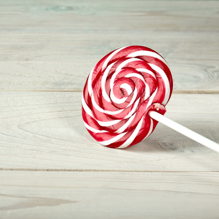 red and white large spiral lollipop on stickの写真素材
