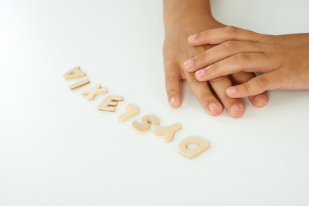hands of a girl form the word dyslexia with wooden lettersの写真素材