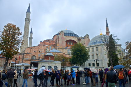 ISTANBUL - TURKEY - OCT 28: Hundreds unidentified tourists visiting every day, defying weather, the Hagia Sophia museum. Hagia Sophia is the greatest monument of Byzantine Culture in Turkey. On October 28, 2014 in Istanbul, Turkeyのeditorial素材
