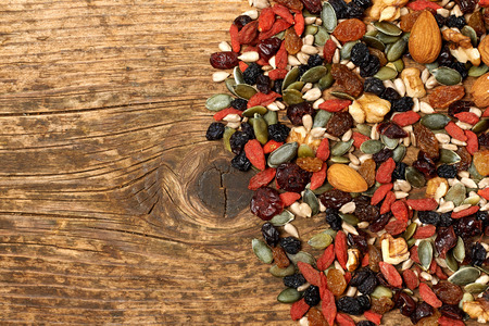mix nuts seeds and dry fruits, on a wooden tableの写真素材