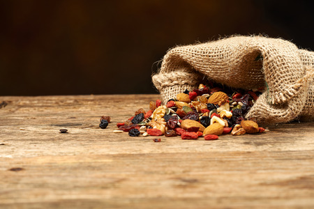 mix nuts seeds and dry fruits, on a wooden tableの写真素材