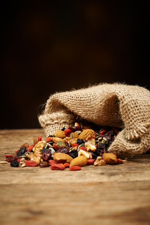 mix nuts seeds and dry fruits, on a wooden tableの写真素材