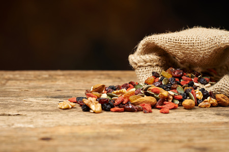 mix nuts seeds and dry fruits, on a wooden tableの写真素材