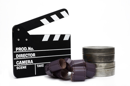 Movie clapper board and 35mm film on white backgroundの写真素材