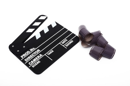 Movie clapper board and 35mm film on white backgroundの写真素材