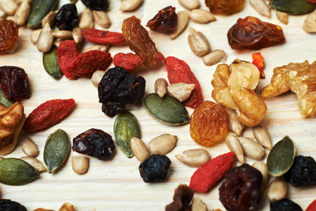 mix nuts seeds and dry fruits, on a wooden tableの写真素材