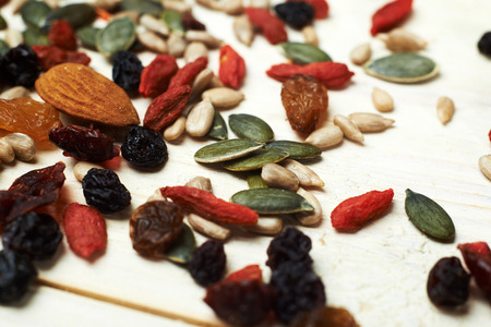mix nuts seeds and dry fruits, on a wooden tableの写真素材