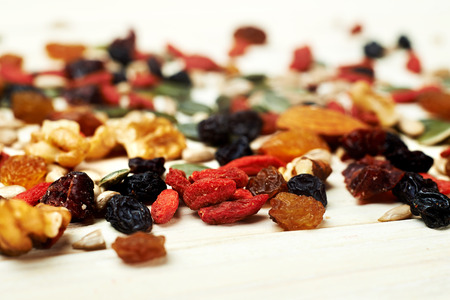 mix nuts seeds and dry fruits, on a wooden tableの写真素材