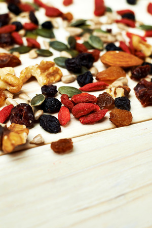 mix nuts seeds and dry fruits, on a wooden tableの写真素材