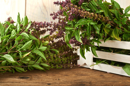 fresh basil on a wooden kitchen benchの写真素材