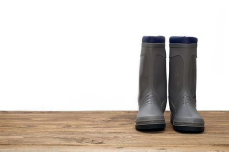 Plastic waterproof boots on a wooden tableの写真素材