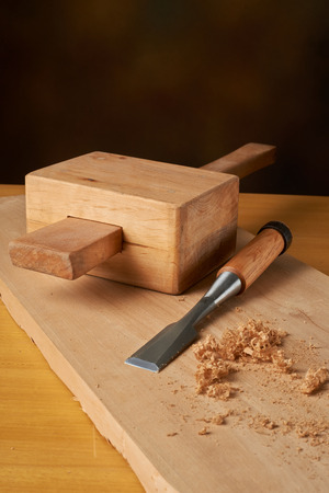 Woodworking tool. Mallet with chisel and savings on a workbench.の写真素材