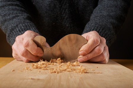 Woodworking tool. Carpenter saving wood with scraper blade.の写真素材